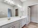 Bathroom with double sinks, white cabinets, and modern fixtures and finishes at 10011 Forest View Ln, Charlotte, NC 28213