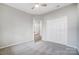 An empty bedroom featuring carpet, neutral colored walls, closet, and a view into a bathroom at 10011 Forest View Ln, Charlotte, NC 28213