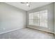 A bedroom featuring carpet, neutral colored walls, and a single window at 10011 Forest View Ln, Charlotte, NC 28213