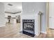 Elegant fireplace featuring a white mantel and view to a bright kitchen with an island at 10011 Forest View Ln, Charlotte, NC 28213