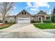 Charming single-Gathering home featuring a two-car garage and brick-accented entryway at 10011 Forest View Ln, Charlotte, NC 28213