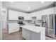 Bright kitchen featuring stainless steel appliances, white cabinetry and an island at 10011 Forest View Ln, Charlotte, NC 28213