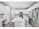 Contemporary kitchen with white cabinets, stainless steel appliances, and a functional island at 10011 Forest View Ln, Charlotte, NC 28213