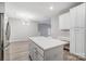 A bright kitchen featuring an island, white cabinets, and stainless steel refrigerator at 10011 Forest View Ln, Charlotte, NC 28213