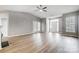 Bright living room with wood floors, vaulted ceiling, and double doors leading to a patio at 10011 Forest View Ln, Charlotte, NC 28213