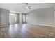 Inviting living room with wood-look flooring, and ample natural light from large front windows at 10011 Forest View Ln, Charlotte, NC 28213