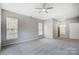 Spacious main bedroom boasts neutral walls, carpet, and natural light from many windows at 10011 Forest View Ln, Charlotte, NC 28213