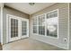 Outdoor patio area featuring vinyl siding, windows, and a door at 10011 Forest View Ln, Charlotte, NC 28213