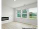 Cozy living room featuring a modern fireplace, large windows, and stylish flooring at 1032 Hostler Ln, York, SC 29745