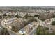 Aerial view of a neighborhood showcasing rows of houses, mature trees and orderly streets at 11712 Huxley Rd, Charlotte, NC 28277