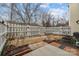 Fenced backyard featuring garden bed with brick borders and a small patio at 11712 Huxley Rd, Charlotte, NC 28277