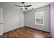 Bedroom featuring ceiling fan, window, and wood-look flooring at 11712 Huxley Rd, Charlotte, NC 28277