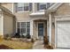 Inviting front entrance with well manicured lawn, walkway, seating area and a view of the garage and house number at 11712 Huxley Rd, Charlotte, NC 28277