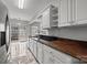 Modern kitchen featuring marble floors, stainless steel appliances, white cabinets, and lots of natural lighting from backyard at 11712 Huxley Rd, Charlotte, NC 28277