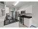 Modern kitchen featuring granite countertops, stainless steel appliances, and white cabinetry at 11712 Huxley Rd, Charlotte, NC 28277