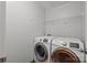 Laundry room featuring front loading washer and dryer with wire shelving at 11712 Huxley Rd, Charlotte, NC 28277