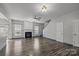 Open living space featuring a fireplace, hardwood floors, and plenty of natural light at 11712 Huxley Rd, Charlotte, NC 28277