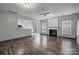 Open living room area with hardwood flooring, fireplace and access to the kitchen at 11712 Huxley Rd, Charlotte, NC 28277