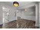 Bright living room with light gray walls, hardwood floors, and modern lighting fixtures, perfect for entertaining and relaxing at 11712 Huxley Rd, Charlotte, NC 28277