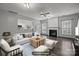 Living room with a fireplace, large windows, and an open floor plan at 11712 Huxley Rd, Charlotte, NC 28277