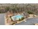 Aerial shot of a sparkling blue community swimming pool surrounded by lounge chairs and manicured landscaping at 11712 Huxley Rd, Charlotte, NC 28277