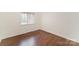 Neutral bedroom with hardwood floors and natural light from the window at 1323 Queens Rd # 202, Charlotte, NC 28207