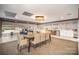 Bright dining area with table and chairs, adjacent to kitchenette and large windows, perfect for gatherings and community meals at 1323 Queens Rd # 202, Charlotte, NC 28207