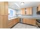 Bright kitchen featuring stainless steel appliances, light wood cabinets and tile flooring at 1323 Queens Rd # 202, Charlotte, NC 28207