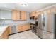 Bright kitchen with stainless steel appliances, light wood cabinets and tile flooring at 1323 Queens Rd # 202, Charlotte, NC 28207