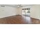 Living room with dark wood floors, ceiling fan, and a balcony through a sliding door at 1323 Queens Rd # 202, Charlotte, NC 28207