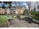 Apartment community outdoor grill and seating area with mature landscaping, providing a perfect space for social gatherings at 1323 Queens Rd # 202, Charlotte, NC 28207