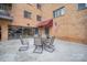 Cozy patio area with outdoor seating, ideal for relaxation, with brick apartment building visible in background at 1323 Queens Rd # 202, Charlotte, NC 28207