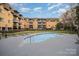 Exterior view of the pool area at brick apartment building with chaise lounges and well-maintained landscaping at 1323 Queens Rd # 202, Charlotte, NC 28207