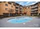 Outdoor pool area with lounge chairs at brick apartment building, creating a relaxing and recreational space for residents at 1323 Queens Rd # 202, Charlotte, NC 28207