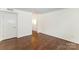 Spacious room with hardwood floors, neutral walls, and ample lighting at 1323 Queens Rd # 202, Charlotte, NC 28207