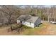 Backyard view of the house with a large backyard and mature trees at 1707 W 4Th Ave, Gastonia, NC 28052