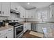 Well-lit kitchen with stainless steel appliances, granite countertops, and ample cabinet space at 1707 W 4Th Ave, Gastonia, NC 28052