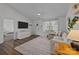 Inviting living room featuring a large window, modern decor, and view into bedroom at 1707 W 4Th Ave, Gastonia, NC 28052