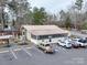 Exterior of a light tan building with parking, picnic tables, and landscaping at 171 Holly Harbor Trl # B62, Mount Gilead, NC 27306