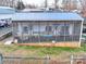 Overhead view of a camper with a screened porch featuring wooden accents, a blue metal roof and a welcoming sign at 171 Holly Harbor Trl # B62, Mount Gilead, NC 27306