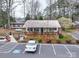 Exterior of a tan building with a parking lot, a wheelchair ramp, and landscaping at 171 Holly Harbor Trl # B62, Mount Gilead, NC 27306