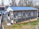 Aerial view of a camper with a screened porch, featuring wood accents and a blue metal roof at 171 Holly Harbor Trl # B62, Mount Gilead, NC 27306