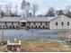 Exterior view of a brick building with a large gravel parking lot at 171 Holly Harbor Trl # B62, Mount Gilead, NC 27306