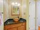 Stylish powder room with mosaic tile, dark granite counter, and vessel sink with a modern faucet at 1906 Overhill Dr, Monroe, NC 28110