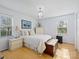 Bright bedroom featuring hardwood floors, a decorative lamp, and a classic wooden chest at 1906 Overhill Dr, Monroe, NC 28110