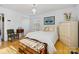 Charming bedroom with a hardwood floor, wardrobe, a bench and a window providing natural light at 1906 Overhill Dr, Monroe, NC 28110