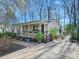 Charming home with a cozy front porch, lovely landscaping, and a patio area perfect for outdoor gatherings at 1906 Overhill Dr, Monroe, NC 28110