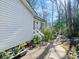 Side of home showcasing a well-maintained exterior, back entrance, with access to a lush garden at 1906 Overhill Dr, Monroe, NC 28110