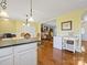 This kitchen flows to the living room showcasing a wet bar, and hardwood floors at 1906 Overhill Dr, Monroe, NC 28110