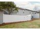 Grassy backyard area enclosed with a pristine white fence at 1915 Colony Line Ct, Charlotte, NC 28210